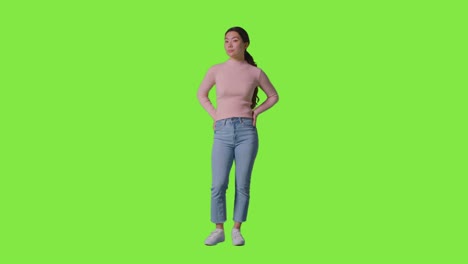Full-Length-Studio-Portrait-Of-Confident-Independent-Woman-Standing-Against-Green-Screen