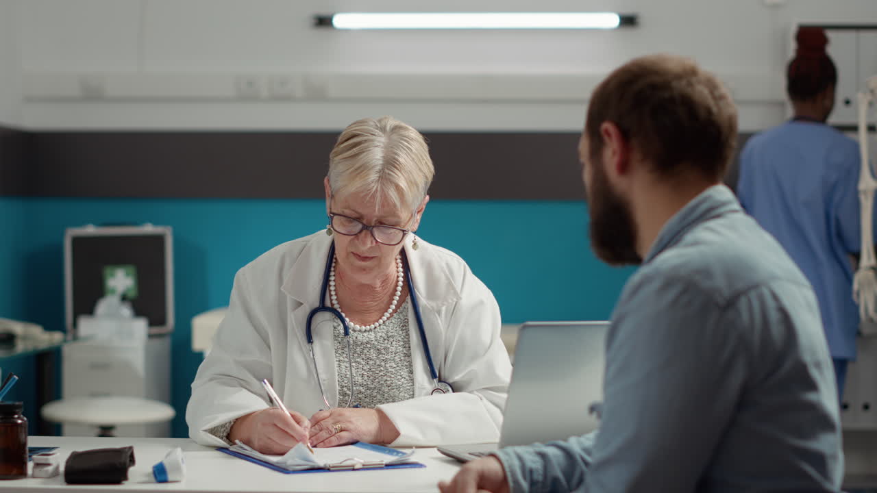 Senior doctor writing consultation information on checkup report