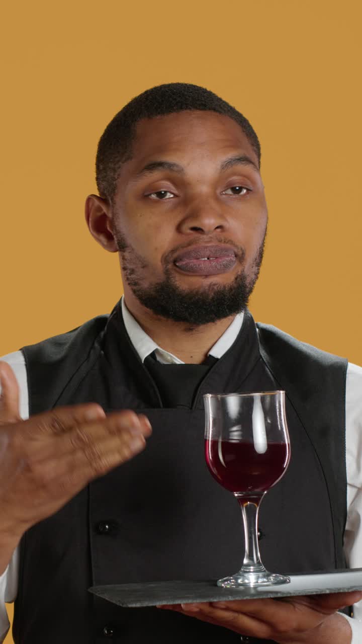 Professional Waiter Explaining Red Wine on Tray