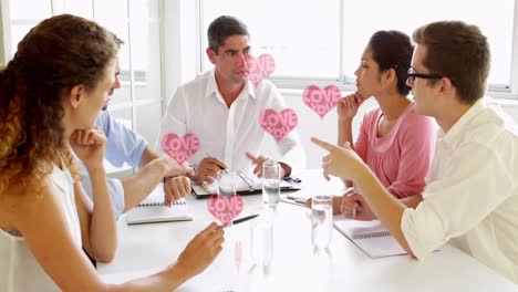 animation of hearts floating over diverse businesspeople working in office