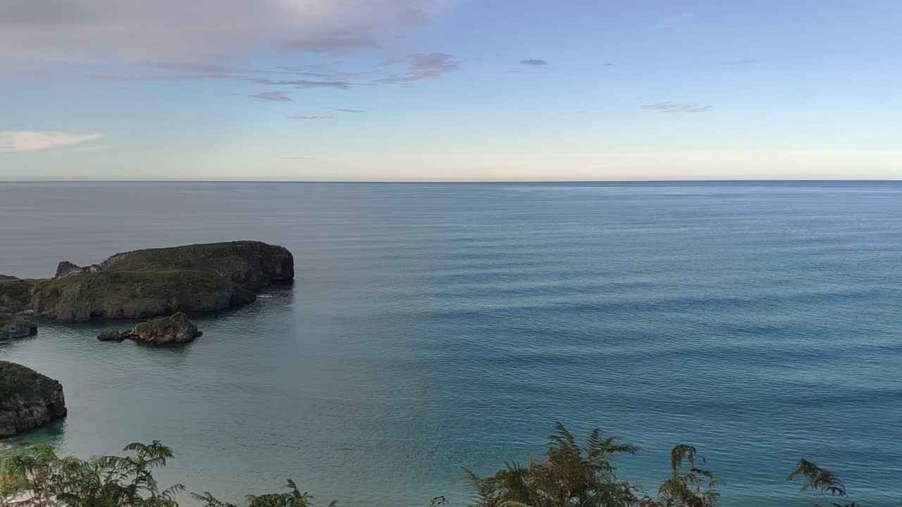 Quiet ocean view from Torimbia beach, peaceful mood with rocky coastline