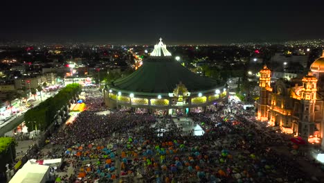 aerial view over people gathered to worship saint mary at the plaza mariana in guadalupe, mexico - rising, reverse, drone shot