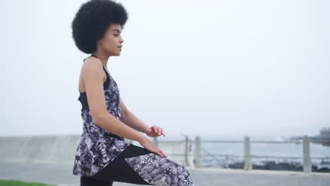 mixed race woman stretching on docks