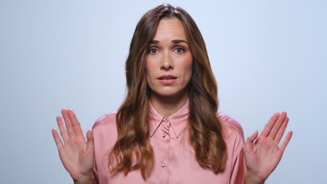 businesswoman gesturing stop sign with hands. girl showing negative gesture