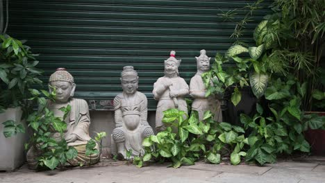 Religious-Buddhist-stone-statues-for-sale-guard-the-entrance-of-closed-antique-shop