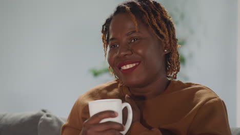 african american woman smiles touched by romantic movie