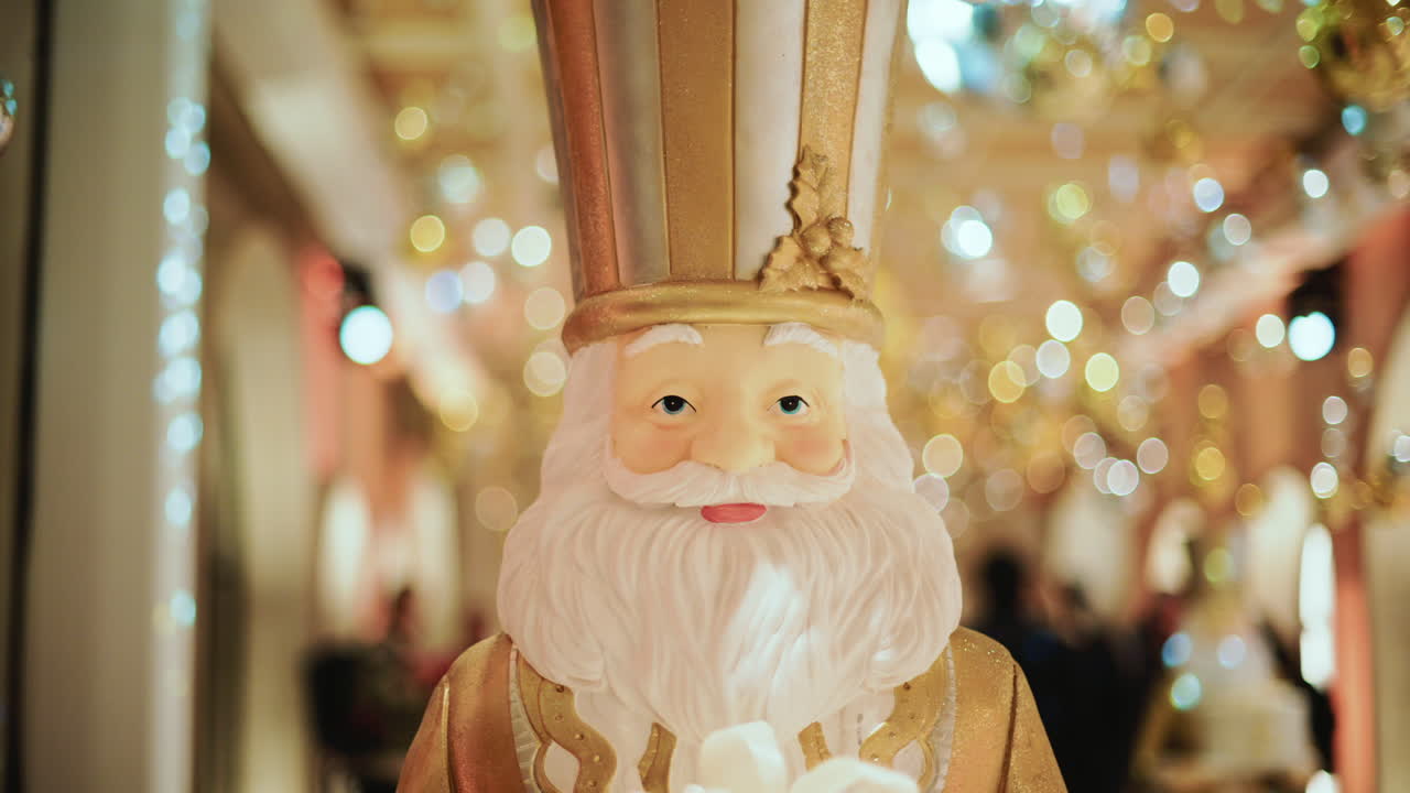 Close up of a Santa Claus figure inside a festive Christmas installation with warm lights and ornaments