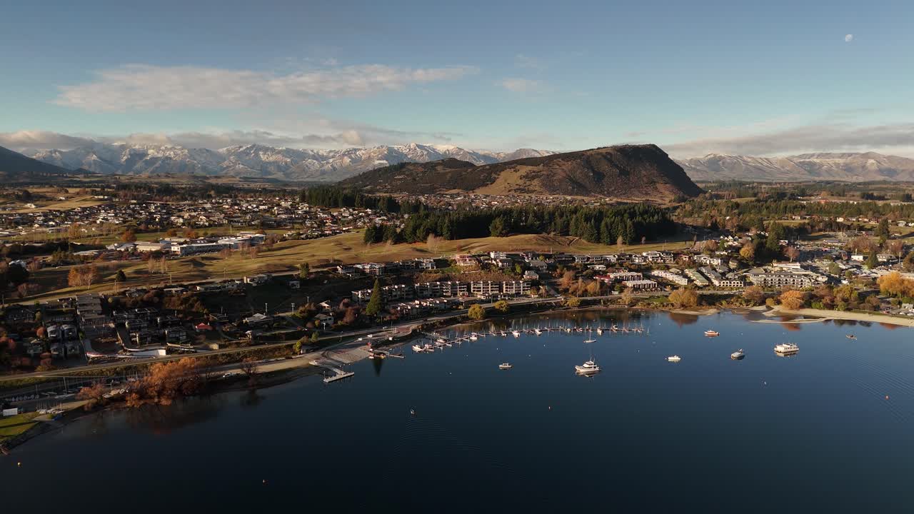 Aerial view of a town with a lake and mountains