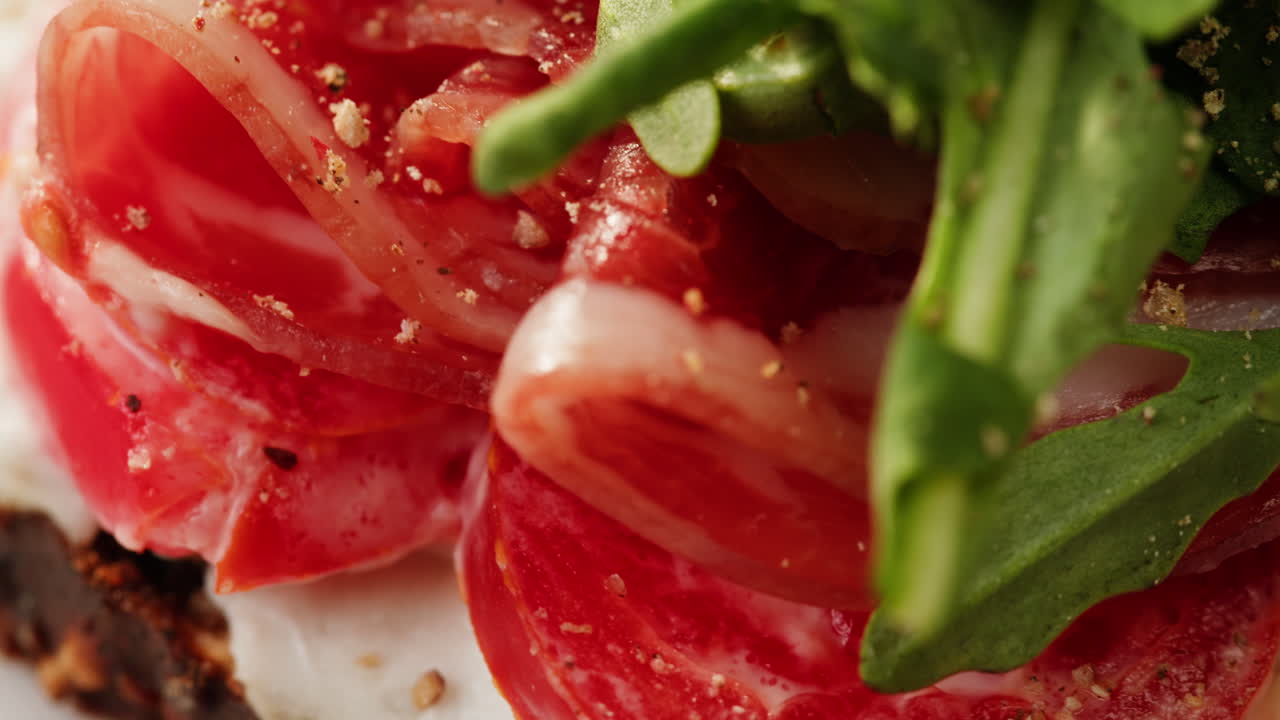 Close-up of a delicious sandwich with ham, tomatoes and arugula