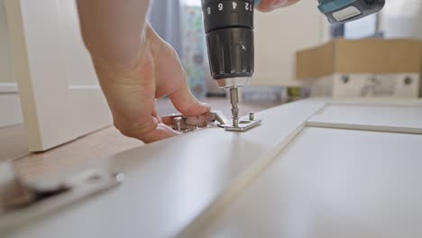 tightening screws using cordless drill, static closeup