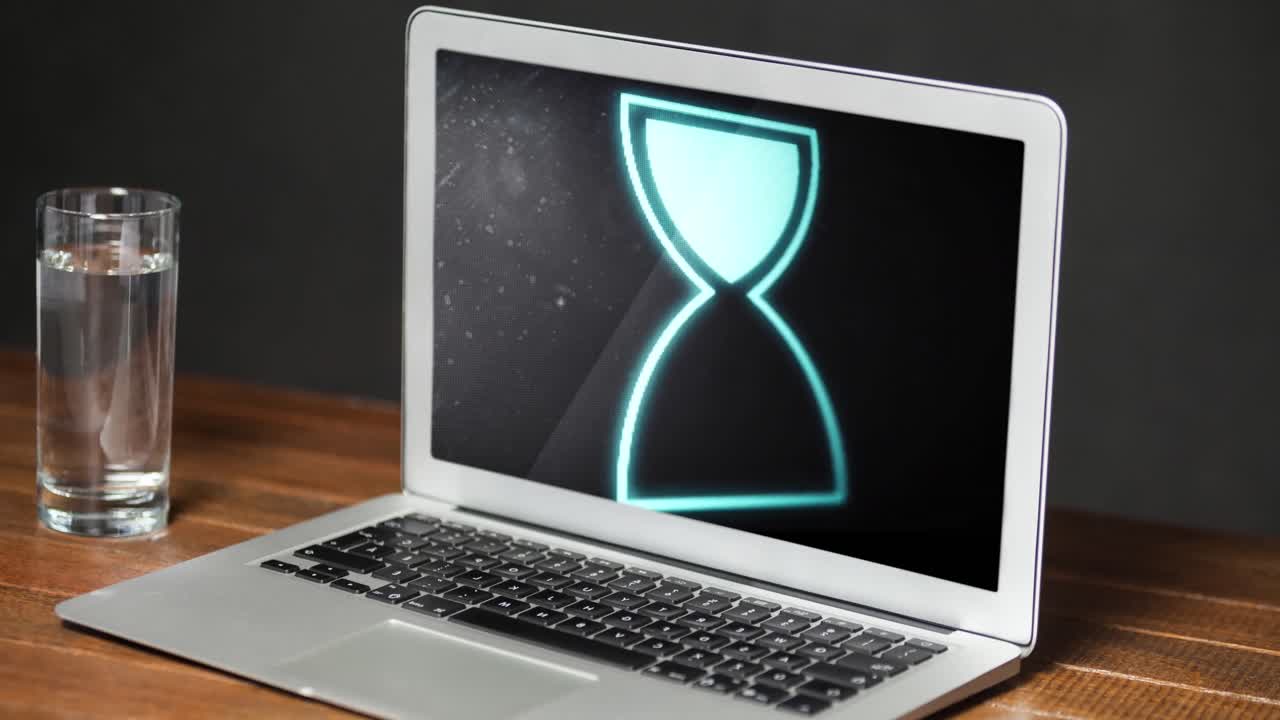 Animation of hourglass icon and data processing on laptop screen