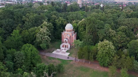 a serene church amid lush greenery at twilight, aerial view