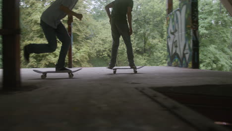 caucasian boys skateboarding in a ruined building.