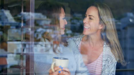 Woman-having-coffee-while-her-partner-hugging-from-back-4k