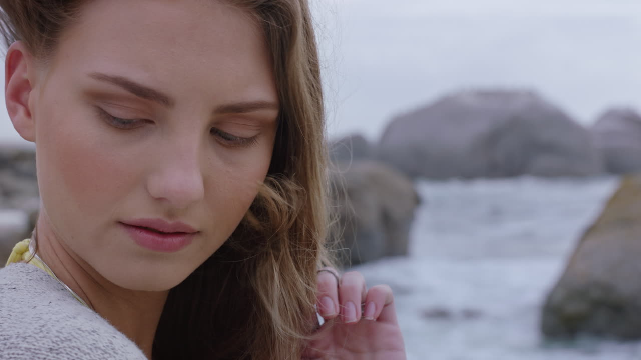 retrato de cerca de una mujer hermosa sonriendo disfrutando de la playa relajándose en la orilla del mar el viento soplando el cabello explorando un estilo de vida tranquilo y despreocupado