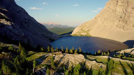 Aerial-Pull-Back-of-Carnarvon-Lake,-Kananaskis,-Alberta,-Canada