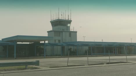 retro airport with an airplane crossing the sky in the background