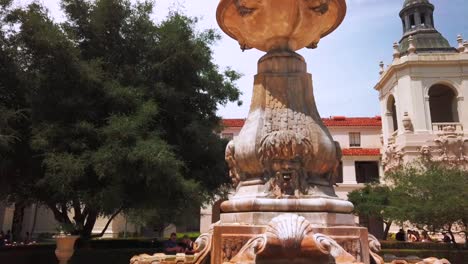 pull back, low profile shot, of water fountain, in courtyard at city hall, pasadena california, on a sunny day