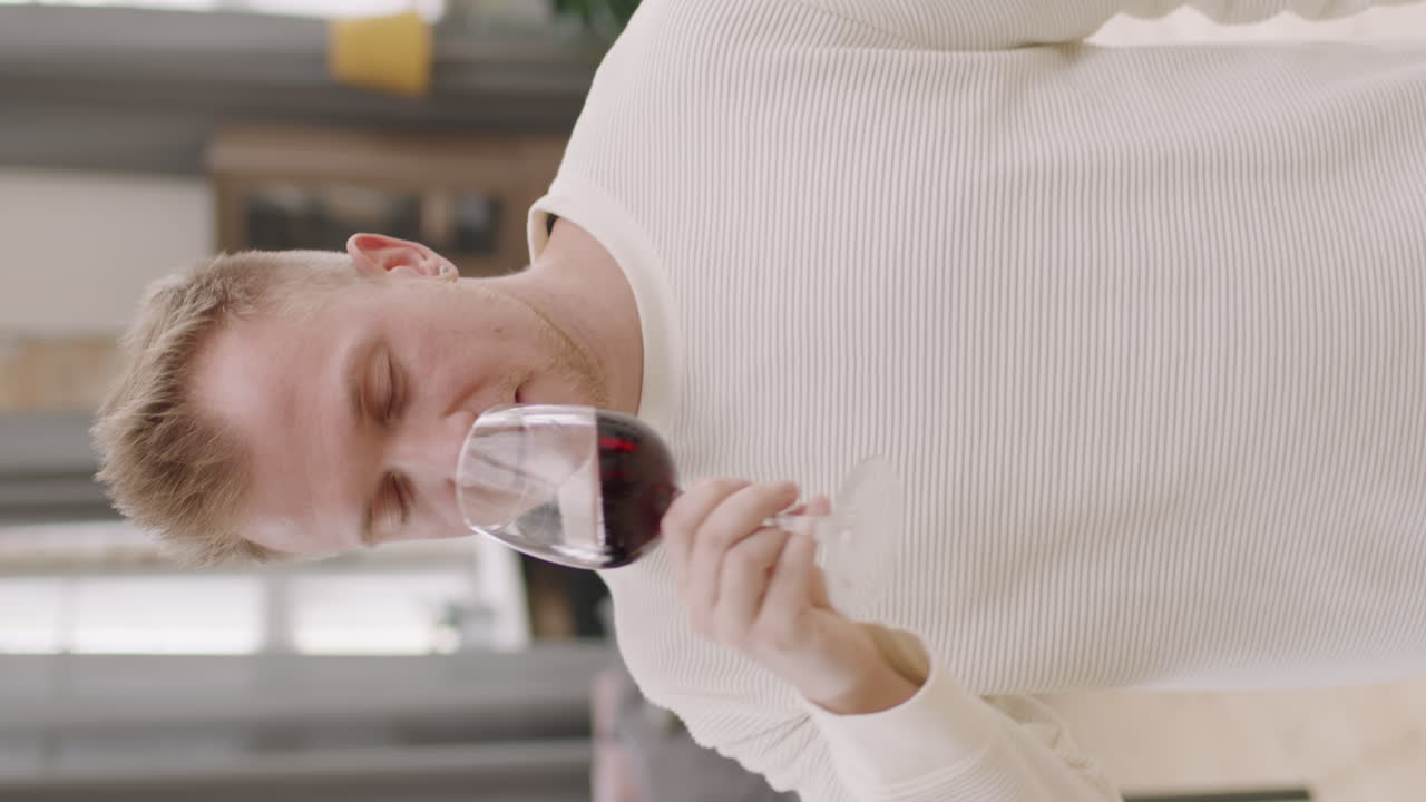 Vertical Portrait of Guy Drinking Red Wine and Dancing