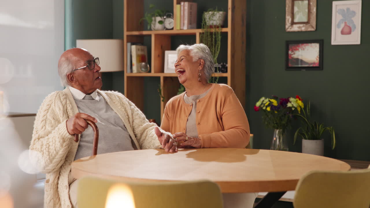 Elderly couple sharing a laugh at home