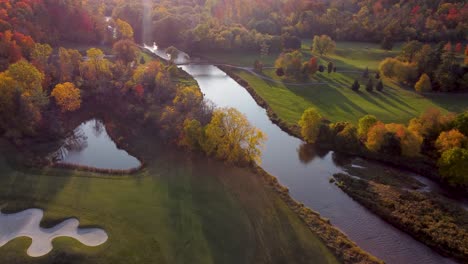 reveal aerial view at park with a river in the middle of it