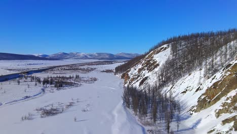 drone flyover near a beautiful mountain in winter