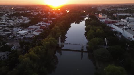 aerial view over the bimodal bridge on río tamazula, sunset in culiacan, mexico