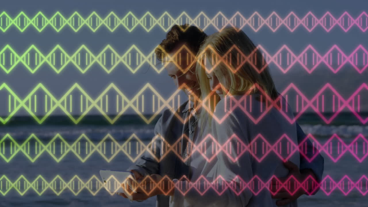 By ocean, couple with colorful DNA strand animation overlaying scene