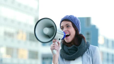 smiling woman shouting with megaphone