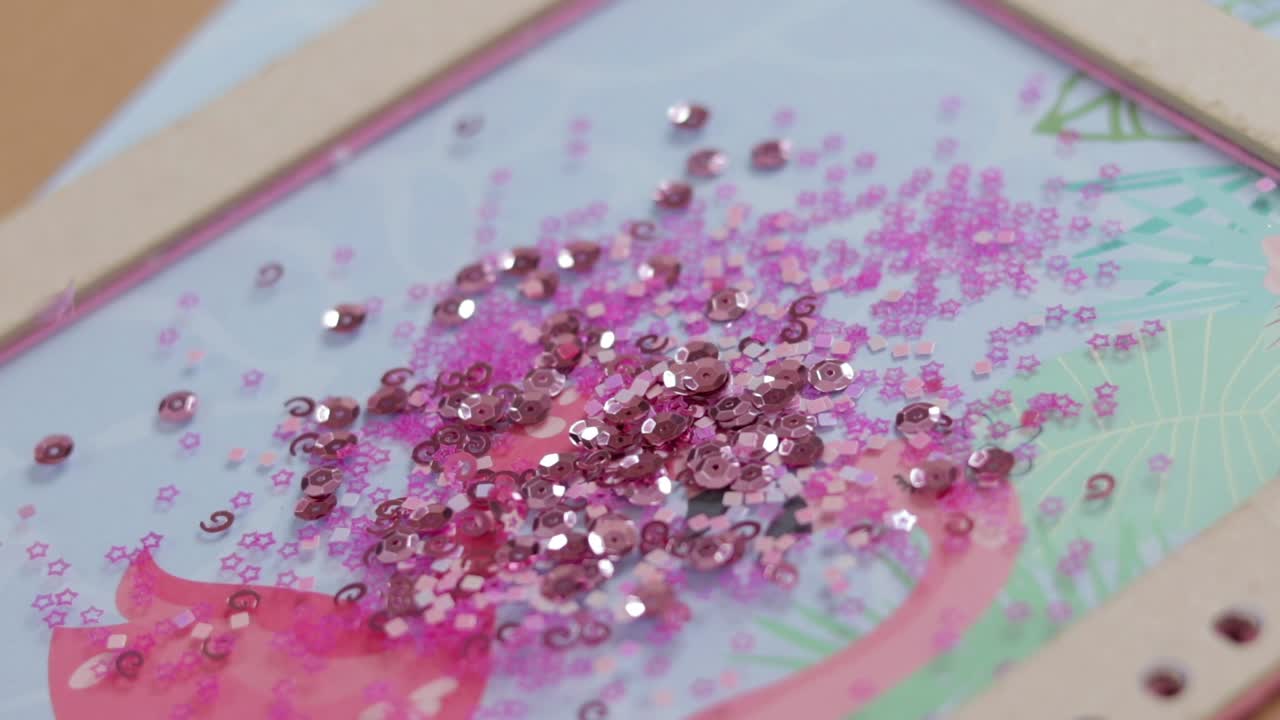 Sequins in different shapes falling on a large glittering pile, close up