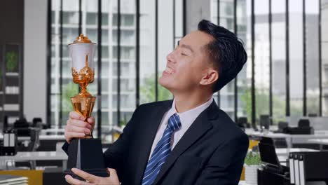 businessman celebrating a trophy win