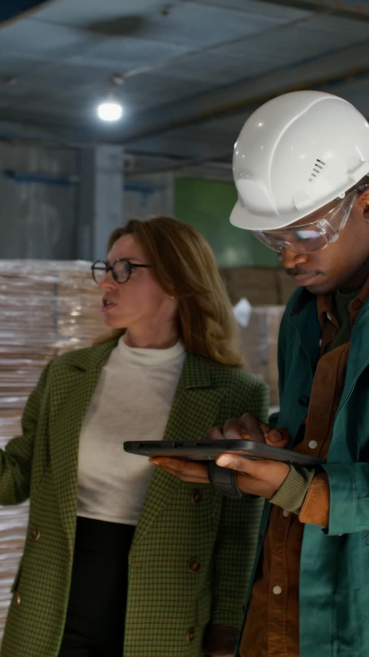 Businesswoman and Warehouse Worker Collaborating