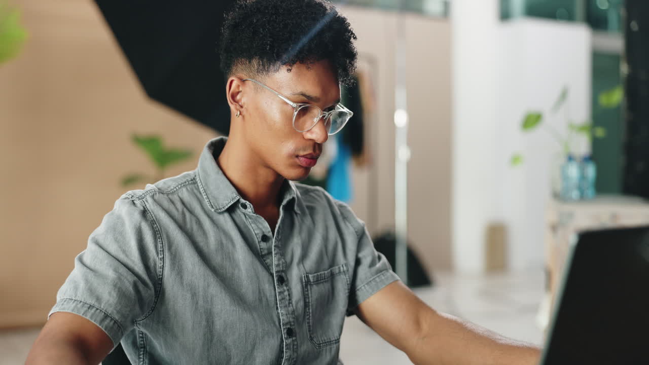 Man Working on a Laptop in a Studio