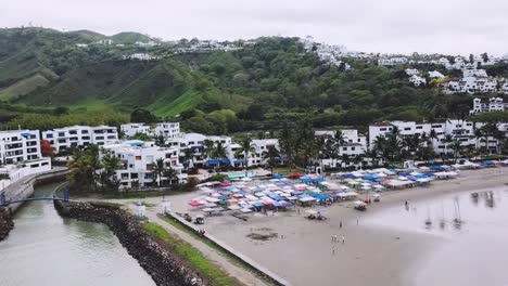 Esmeraldas-Ecuador-coastline-sand-tropical-beach-with-people-on-holiday-and-full-book-accomodation,-aerial-view-tourist-travel-holiday-destination