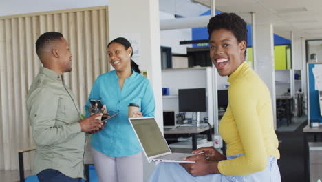portrait of african american businesswoman using laptop at office, slow motion
