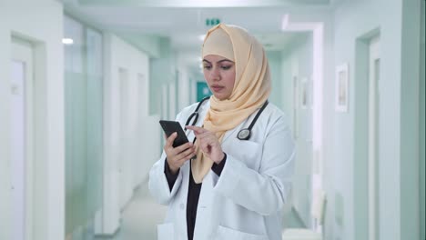 muslim doctor using a phone