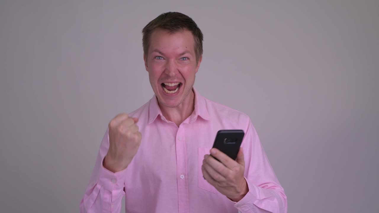Young handsome businessman with pink shirt