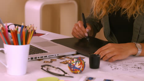 graphic designer using digitizer at her desk