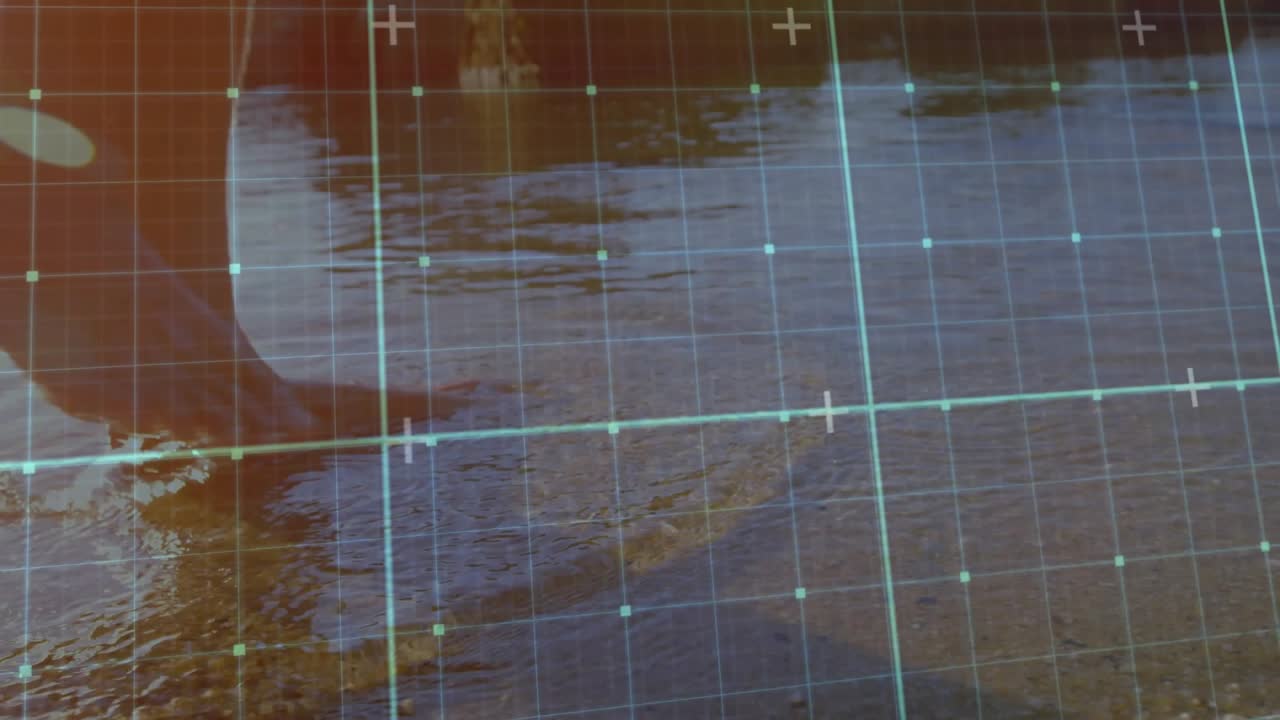 Man shifting weight for testing shallow water depth near posts while tech grid scanning wet pebbles