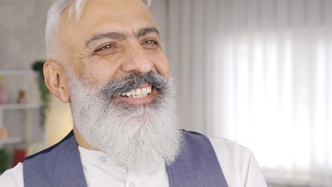 Mature man laughs.