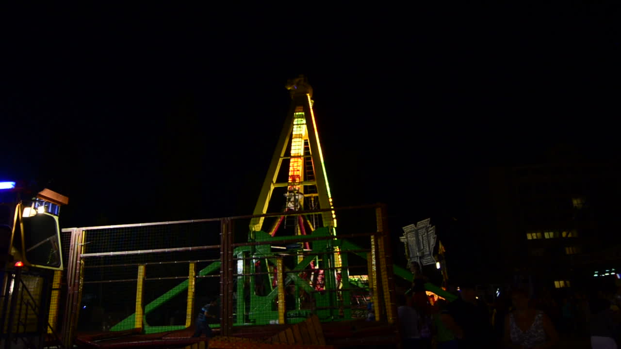 Amusement Fair Park At Night. Holiday night amusement park with flashing lights illumination with swings