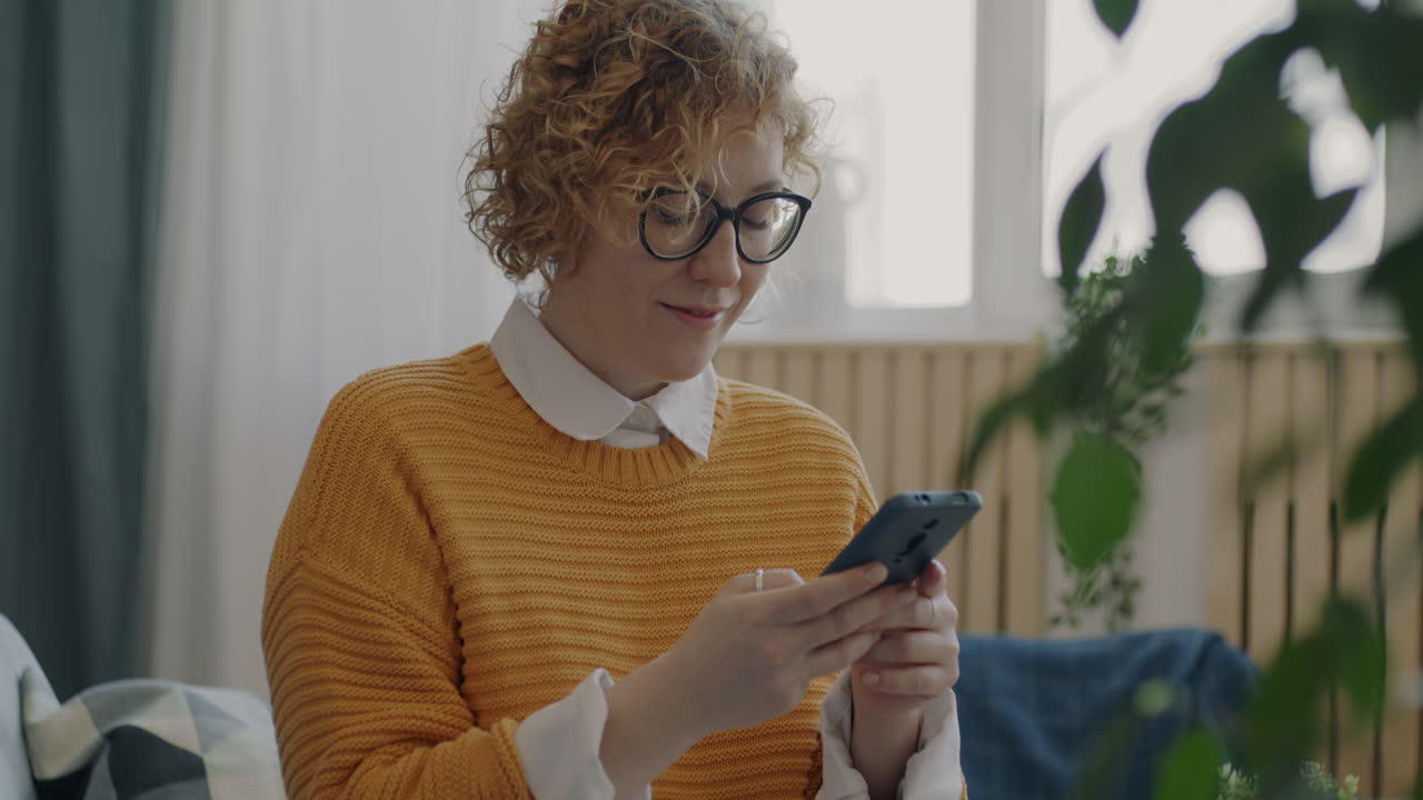 Woman Using Smartphone at Home