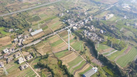 drone shots of a large chinese windfarm located in the valley of sichuan