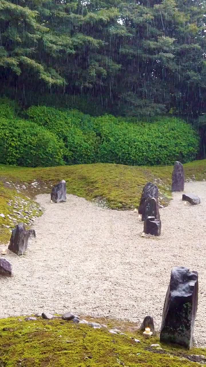 Vertical Japanese Zen Garden under the rain, with Stones and Trees at Kyoto Temple