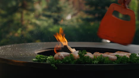 Unknown-man-using-campfire-spatula-on-backyard.-Sausages-browning-on-grill