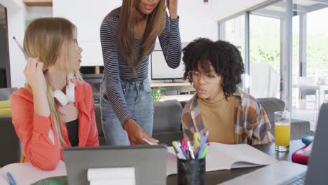 Happy-diverse-teenager-girls-friends-using-laptop-and-learning-together-at-home,-slow-motion