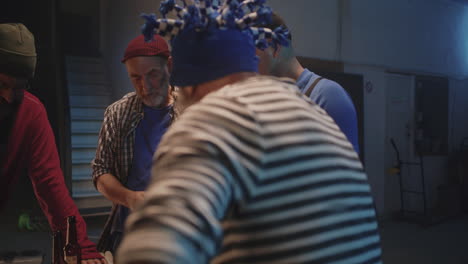 elderly men engaged in a card game and socializing in a garage