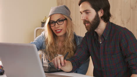 casual designers working on a graphic tablet