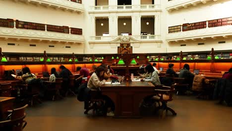 people studying in a grand library hall