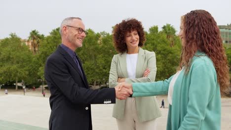 business handshake in an outdoor meeting